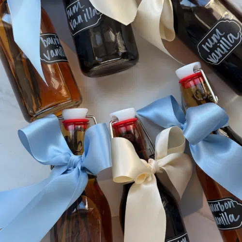 Bourbon and rum vanilla extract aging in glass jars