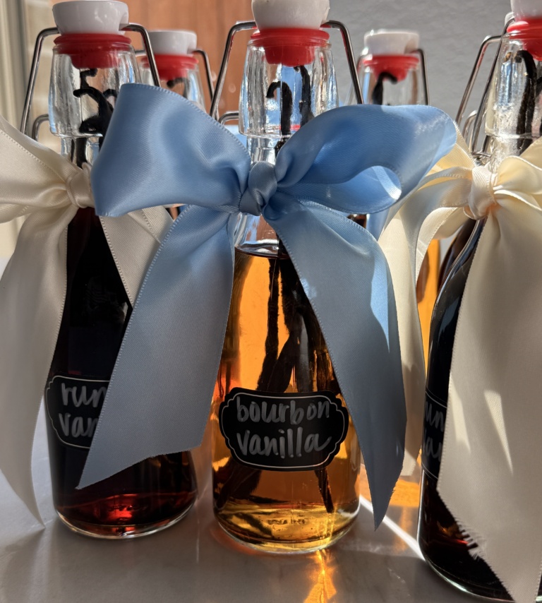 Homemade vanilla extract in glass bottles with vanilla beans