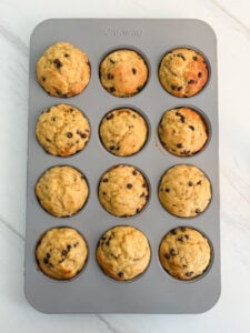 Banana bread freezer muffins with chocolate chips cooling on a wire rack